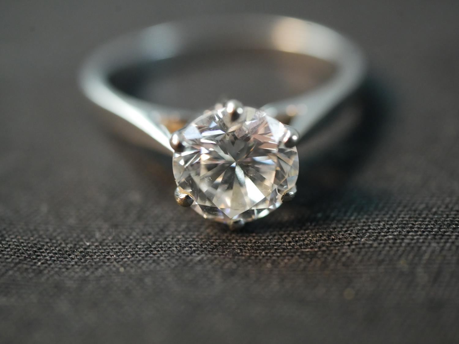 An 18 carat white gold solitaire diamond ring, set with a round old cut diamond in an open back - Image 7 of 7