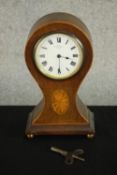 An Edwardian walnut and marquetry inlaid balloon mantel clock, the case inlaid with an oval