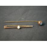 A yellow metal boulder opal stick pin, with carved and polished boulder opal ball to the end (good