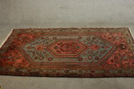 A hand made Persian Hamadan carpet with central lozenge medallion on a pale blue ground within