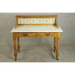 A late Victorian marble and satin birch washstand, the gallery back set with six tiles, over a white