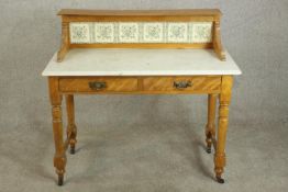 A late Victorian marble and satin birch washstand, the gallery back set with six tiles, over a white