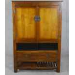 A late 20th century Chinese hardwood television or HiFi cabinet, with two cupboard doors over
