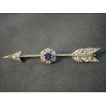 A Victorian silver and red metal diamond and sapphire arrow brooch. Set to centre with a round mixed