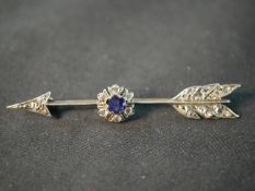 A Victorian silver and red metal diamond and sapphire arrow brooch. Set to centre with a round mixed