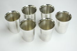 A collection of six Indian white metal (tests as silver) beakers with flared rims. Stamped B100 to