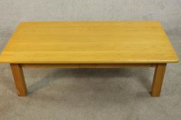 A contemporary oak coffee table, of rectangular form with two frieze drawers on square section legs.