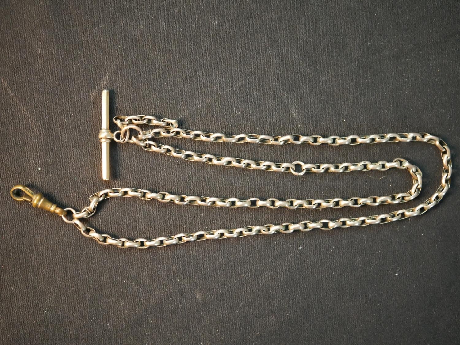 A Victorian hollow rolled rose gold watch chain with albert clasp and T-bar. Gross weight 18.94g