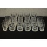 A collection of eighteen cut crystal tumblers and highball glasses. Various makers and designs. H.15