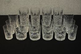 A collection of eighteen cut crystal tumblers and highball glasses. Various makers and designs. H.15