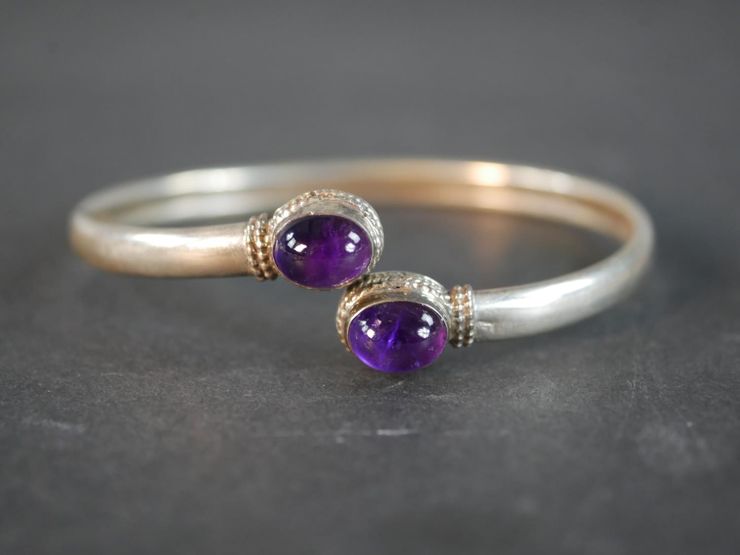 A collection of silver and white metal jewellery, including an amethyst cabochon bangle, an Indian - Image 3 of 7