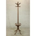 A 20th century bentwood hat and coat stand, with five curved hooks, on four splay supports. H.182