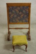 A William IV walnut fire screen with Paisley fabric panels, the legs joined by a turned stretcher,