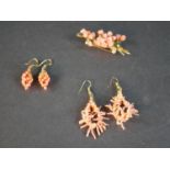 A collection of coral jewellery, including a pair of coral bead grape earrings with gilded leaves, a