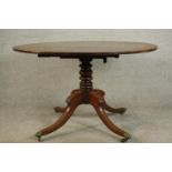 A mid 19th century mahogany tilt top breakfast table, with a circular crossbanded top on a turned