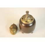 A Japanese bronze incense burner with gilded pierced lid in the form of a fruit on three splayed