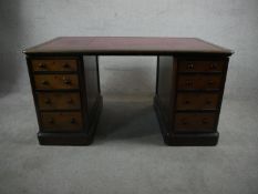 A late Victorian walnut pedestal desk, the top with a tooled bugundy leather skiver over two