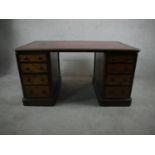 A late Victorian walnut pedestal desk, the top with a tooled bugundy leather skiver over two