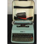 An Italian Olivetti Lettera 32 portable typewriter, in case. H.10 W.30 D.36cm.