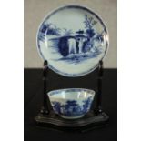 A Chinese Nanking Cargo blue and white porcelain tea bowl and saucer on ebonised stand. (Lot 5064 at