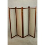 An Edwardian walnut fourfold screen, each panel upholstered with an oatmeal coloured fabric, with