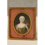 A framed and glazed 19th century miniature oil on panel of a lady in fine dress, unsigned.