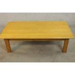 A contemporary oak coffee table, of rectangular form with two frieze drawers on square section legs.