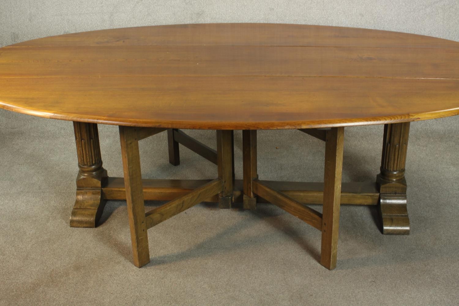 A 20th century oak drop leaf wake table, the oval top with two drop leaves raised on gate legs and - Image 9 of 12