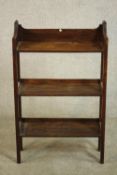 An Arts & Crafts oak book shelf, the gallery back with spade detail, over three shelves on square