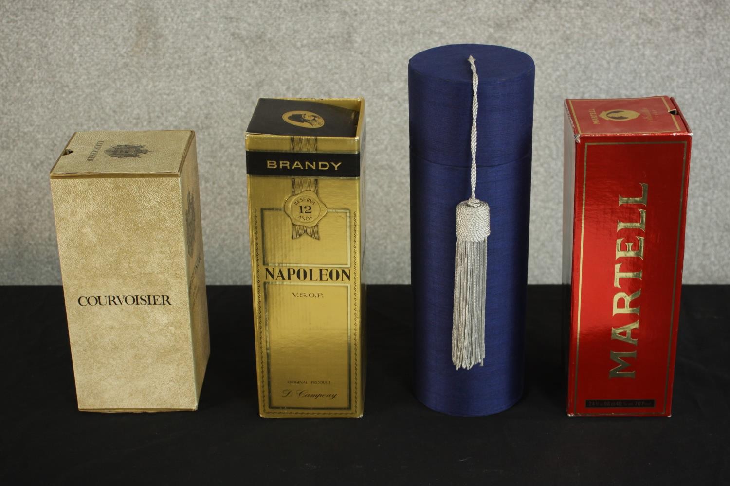 Four bottles of boxed spirits and champagne, including a bottle of Courvoisier Extra Vieille cognac,