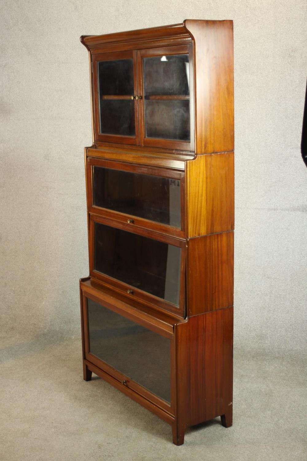 A mid 20th century mahogany Gumm stacking bookcase, with two glazed cupboard doors over three - Image 9 of 16