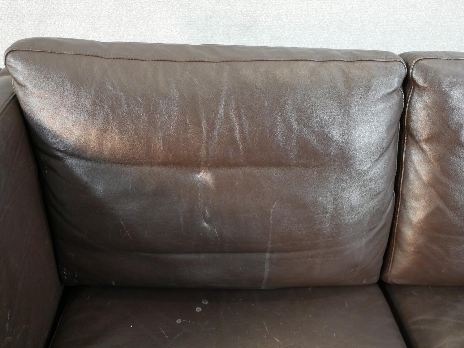 A 1970s Danish style two seater sofa, upholstered in dark brown leather, on square section legs. H. - Image 3 of 5