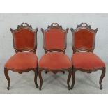 A set of three late 19th/early 20th century French walnut Louis XV style dining chairs,