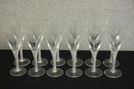 A set of twelve clear glass air twist stem champagne glasses. H.20 Dia.7cm. (largest)