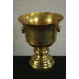A large early 20th century brass twin handled urn on stepped pedestal base. H.33 Dia.30cm.