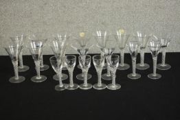 A collection of twenty clear glass double air twist stem glasses, including five cordial glasses and