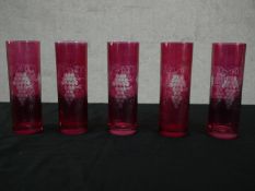 A set of five early 20th century etched vine design cranberry glass glasses. H.17 Dia.6cm.