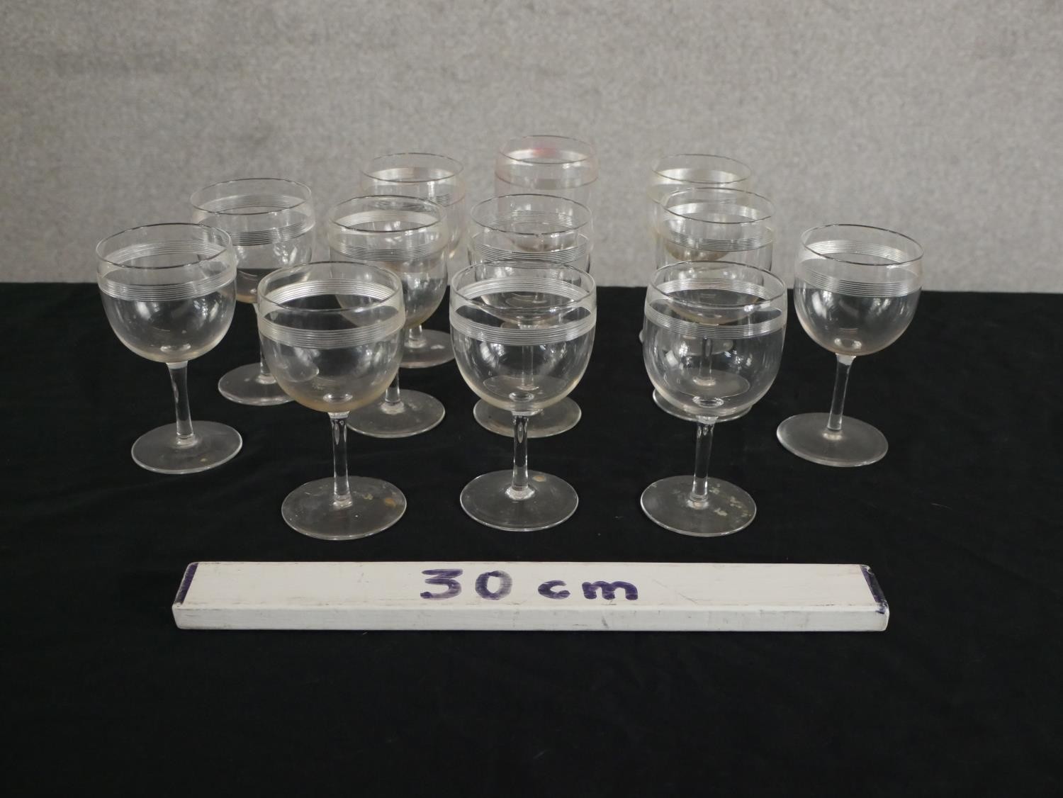 A set of twelve Victorian engraved stemmed glasses with horizontal line detailing. H.12 Dia.7cm. - Image 2 of 4
