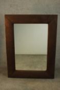 A contemporary rectangular mirror in a brown faux suede cushion frame. H.122 W.90cm