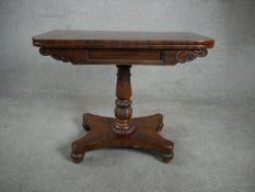 A William IV mahogany card table, with a crossbanded top and green baize interior, on a turned and