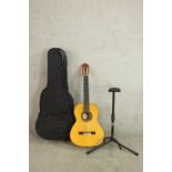 A cased Amalio Burguet acoustic guitar. Model 3F, serial 0329, 2009 with stand.