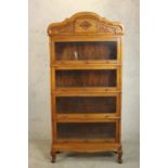 An early 20th century Eastern hardwood, possibly Narra wood (amboyna) sectional stacking bookcase.