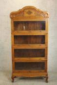 An early 20th century Eastern hardwood, possibly Narra wood (amboyna) sectional stacking bookcase.