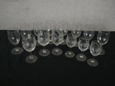 A collection of fourteen glasses, a set of eight ribbed design wine glasses and six etched with