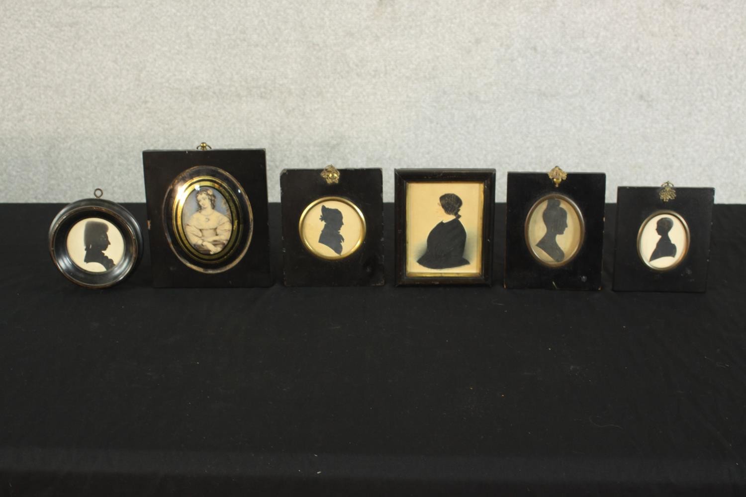 Six framed and glazed 19th century shadow portraits and one print of a lady in best dress. H.15 W.
