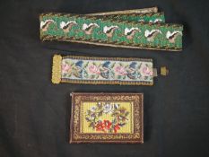 An early 20th century hand beaded leaf design belt, a floral beaded covered notebook and a beaded