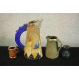 Three art pottery jugs and a blue glaze vase. One jug with abstract design by Jill Fanshawe-Kato