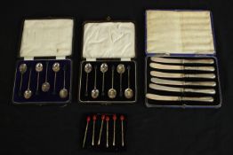 A collection of silver cutlery, including two cased sets of silver coffee spoons with coffee bean