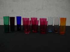 A collection of twelve coloured glasses, including a set of six Victorian cranberry glass cordial