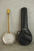 A Framus four string banjo in soft carry case..